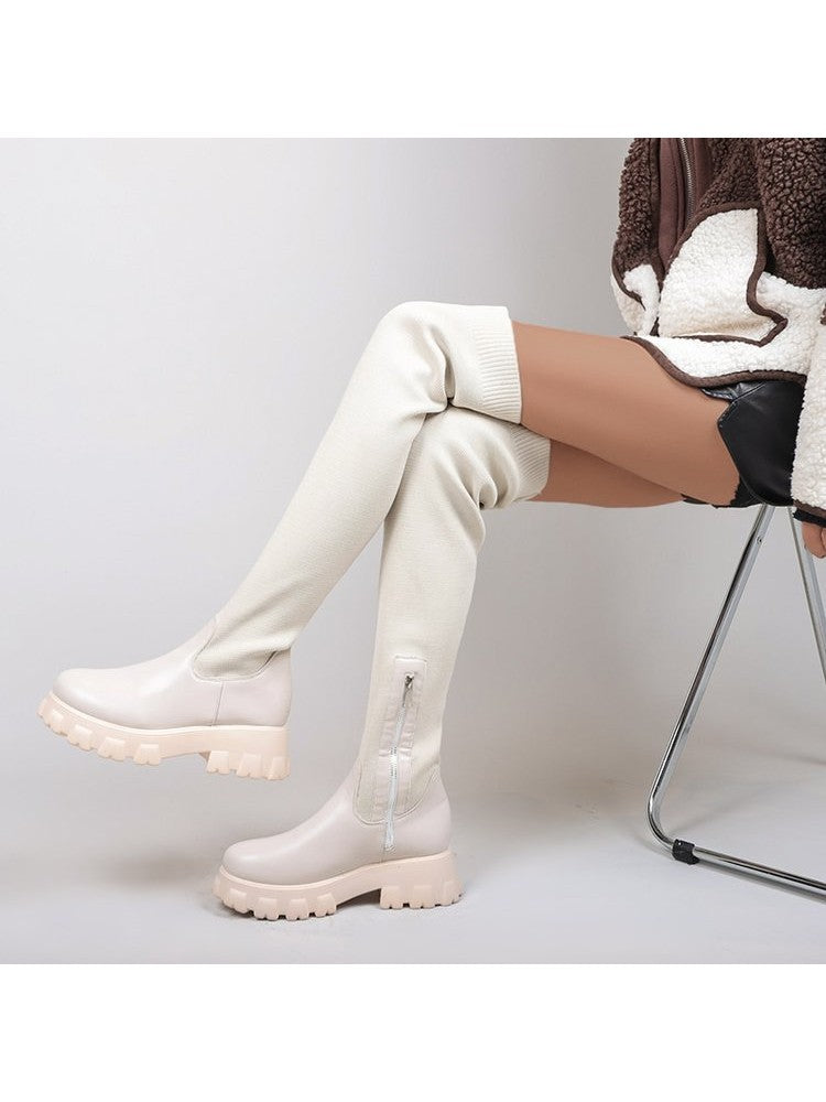 Wholesale7 patchwork over the knee boots in beige with chunky soles worn by model sitting on chair