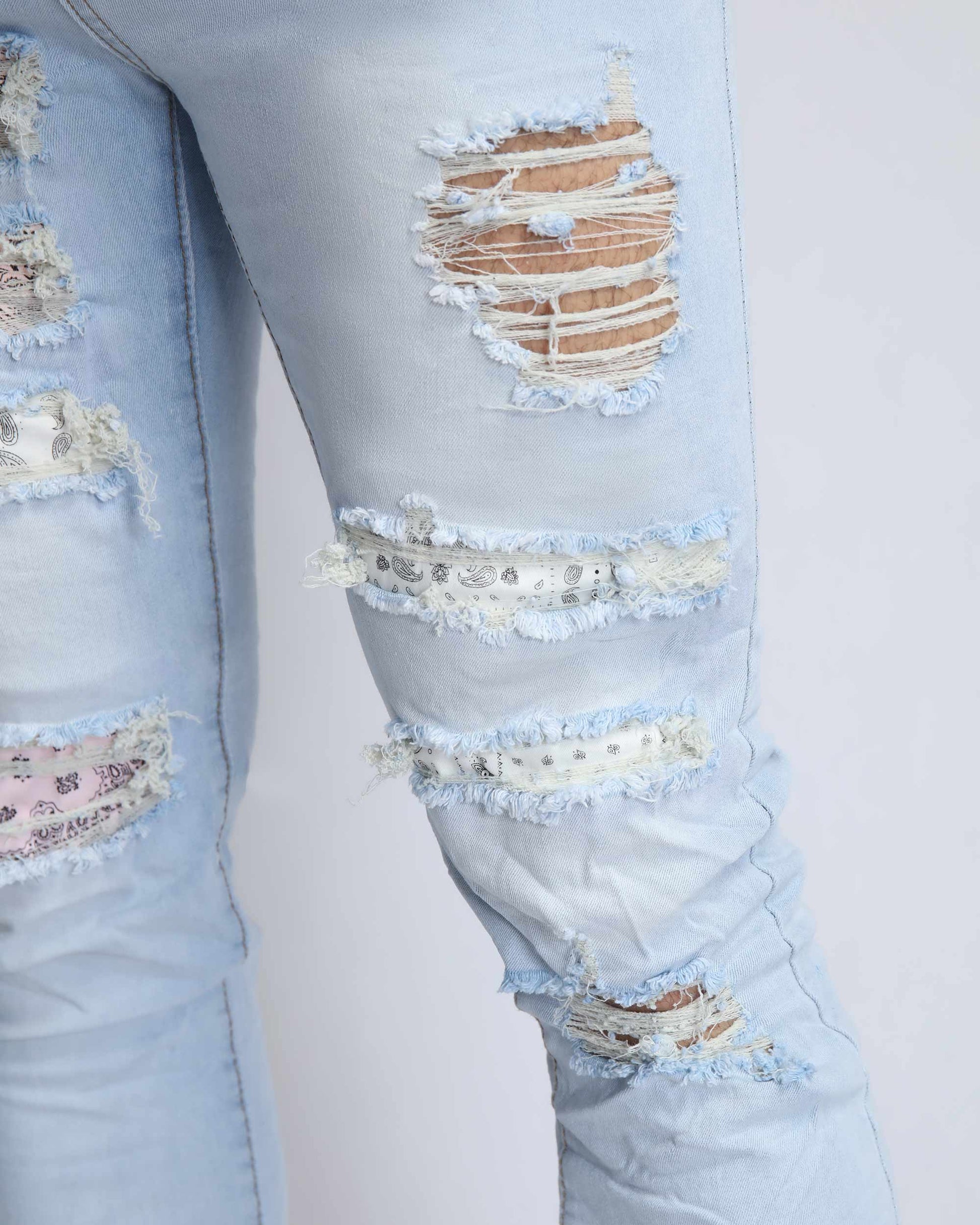 Light blue distressed Logeqi pink cashew blossom jeans with frayed patches and a trendy look