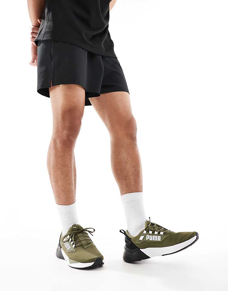 PUMA Retaliate 3 black sneakers worn with athletic shorts and white socks for a stylish look