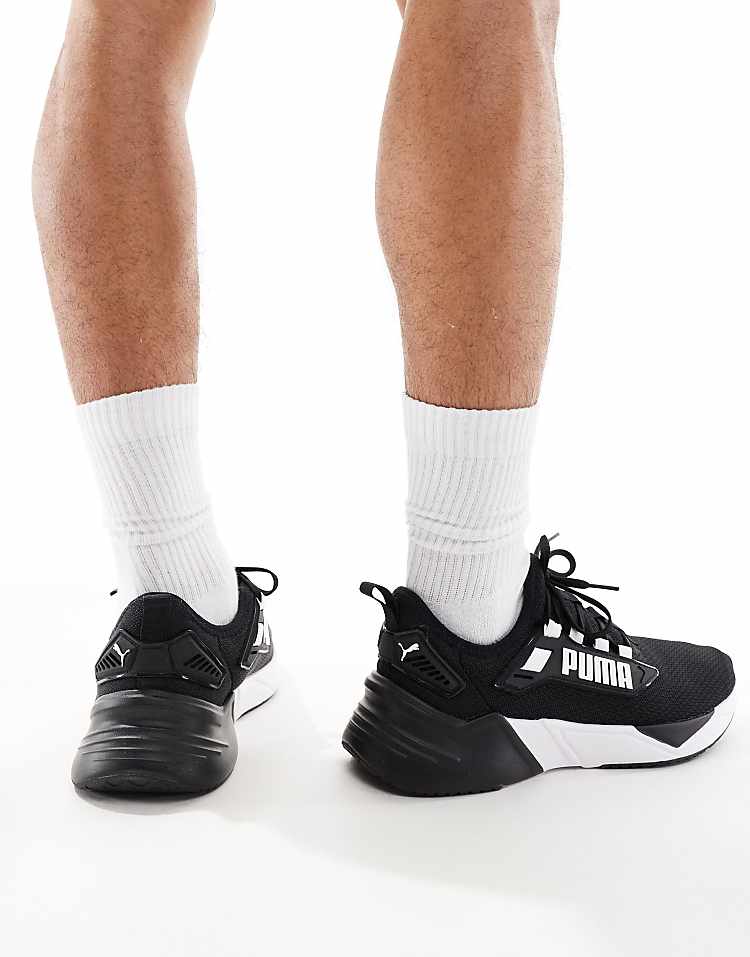 PUMA Retaliate 3 black sneakers with white detailing, perfect for active lifestyles and daily wear