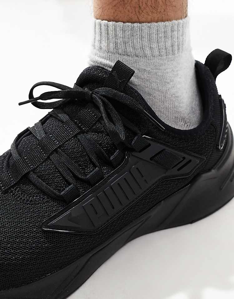 Close-up of PUMA Retaliate 3 black sneakers featuring a sleek design and comfortable fit