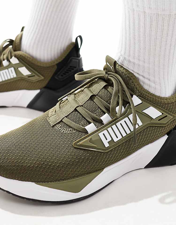 Men wearing PUMA Retaliate 3 black sneakers with breathable mesh upper and stylish design