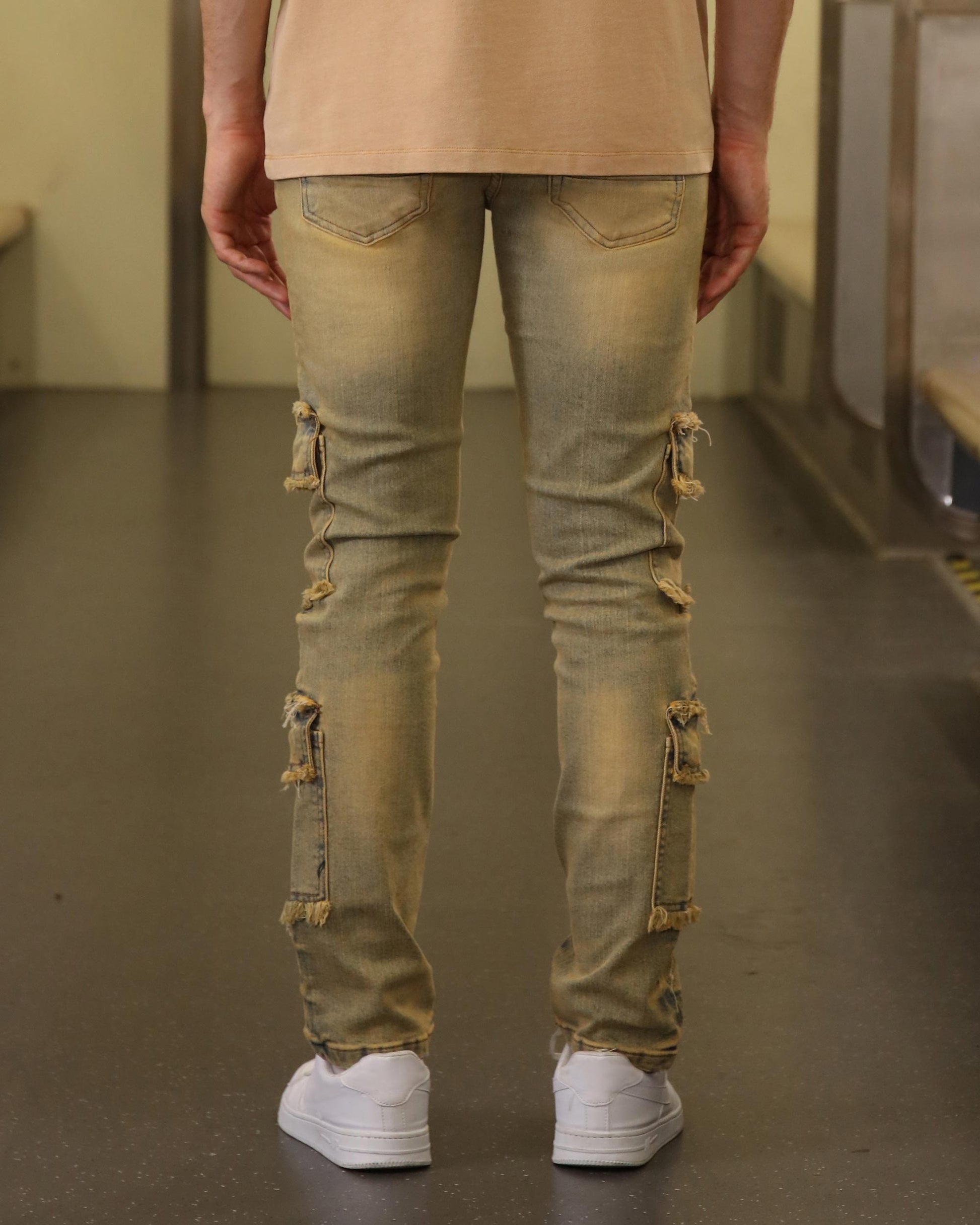 Logeqi raw edge brown jeans with distressed details and ripped patches on the back of legs