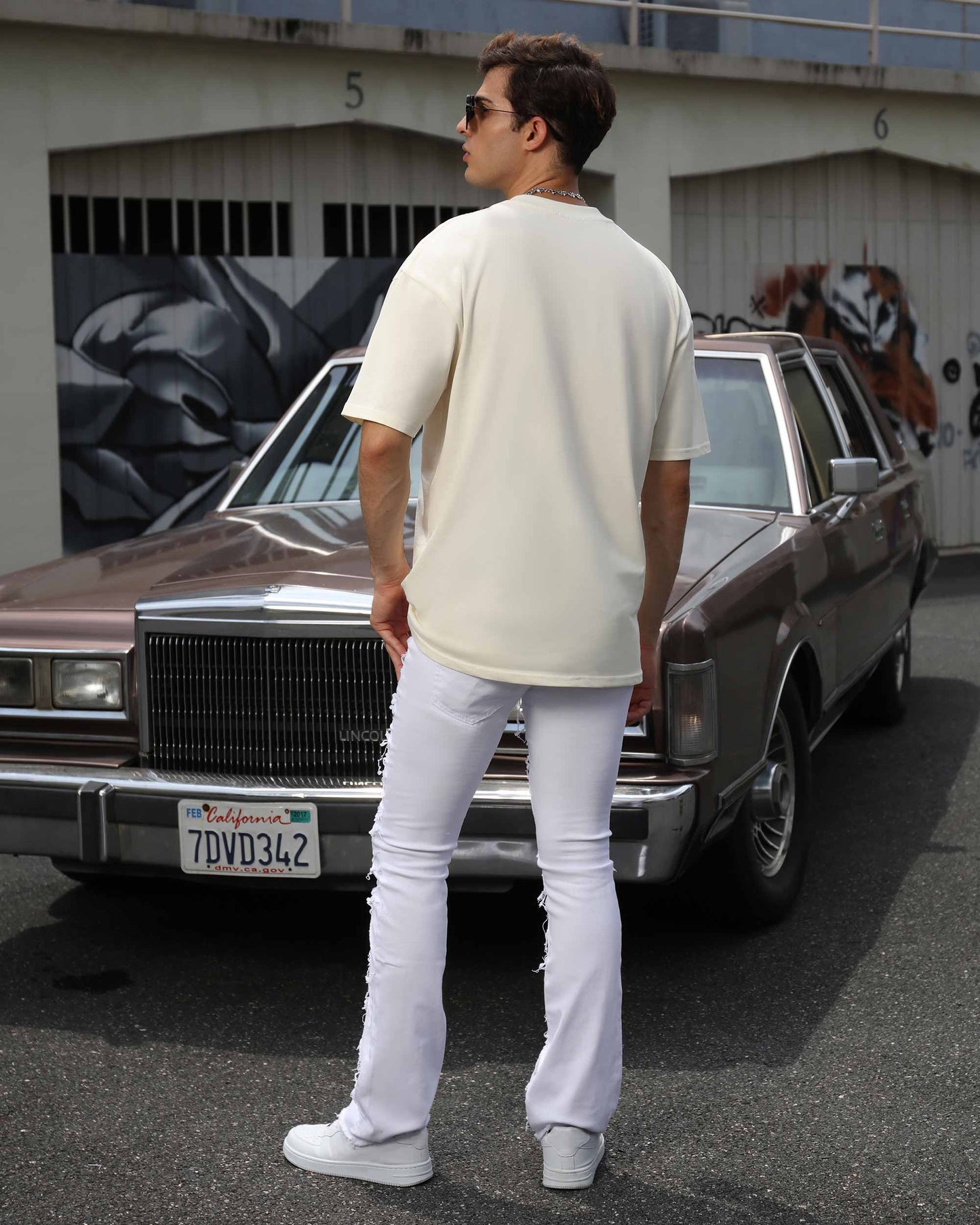 Logeqi retro white flared jeans styled with a casual tee and sunglasses for a chic look