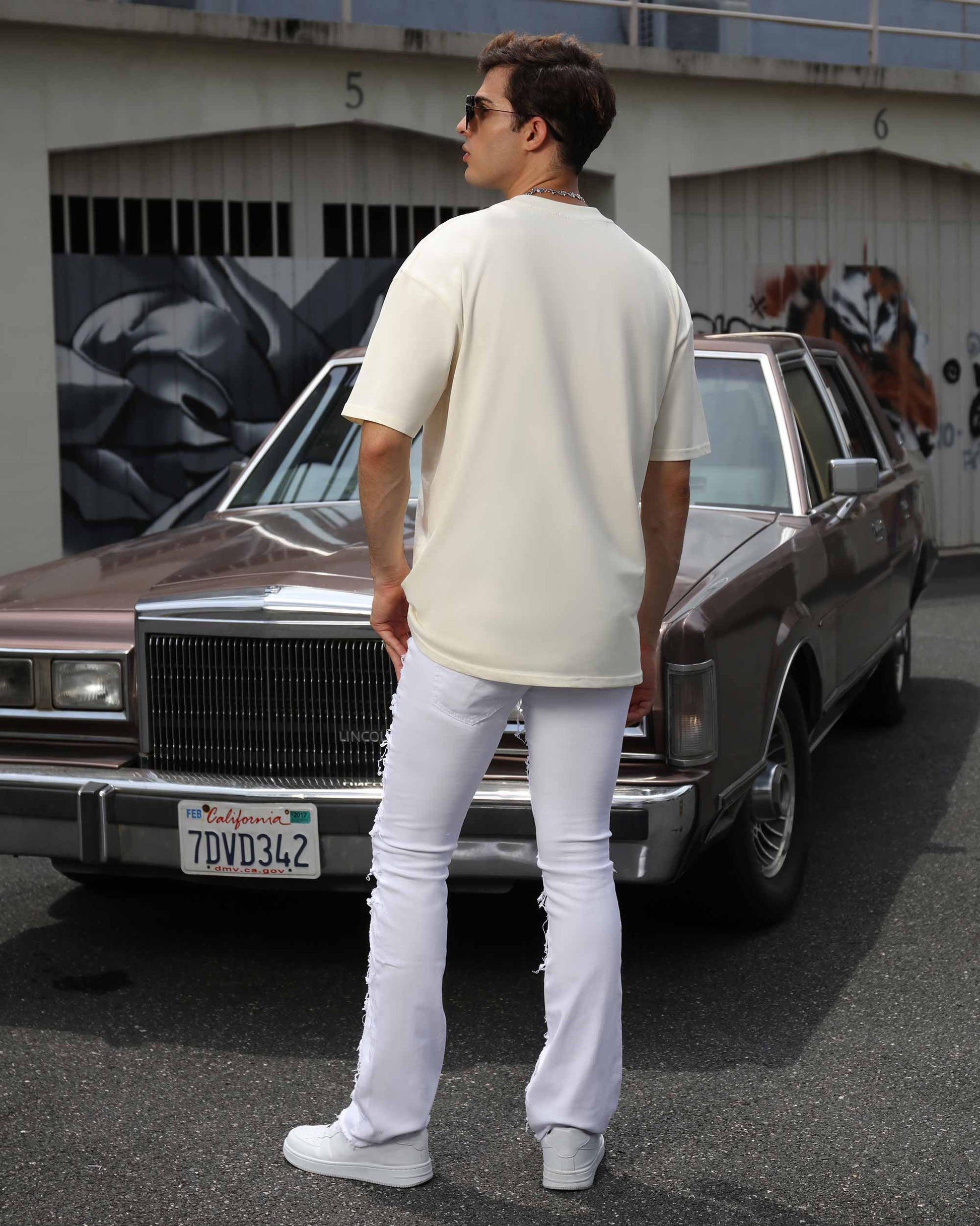 Logeqi retro white flared jeans styled with a casual tee and sunglasses for a chic look