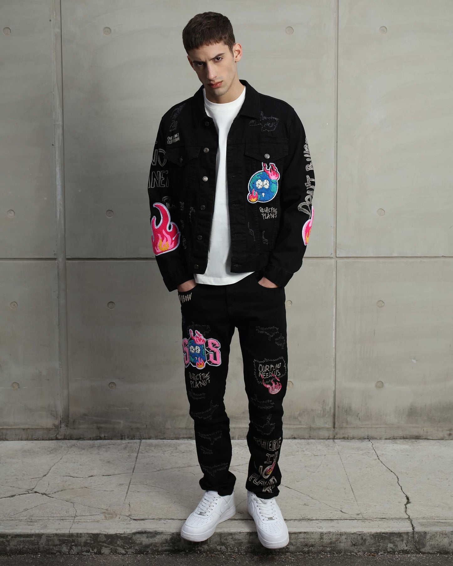 Ripped black denim jacket by Logeqi with colorful graffiti designs and stylish fit for a trendy look