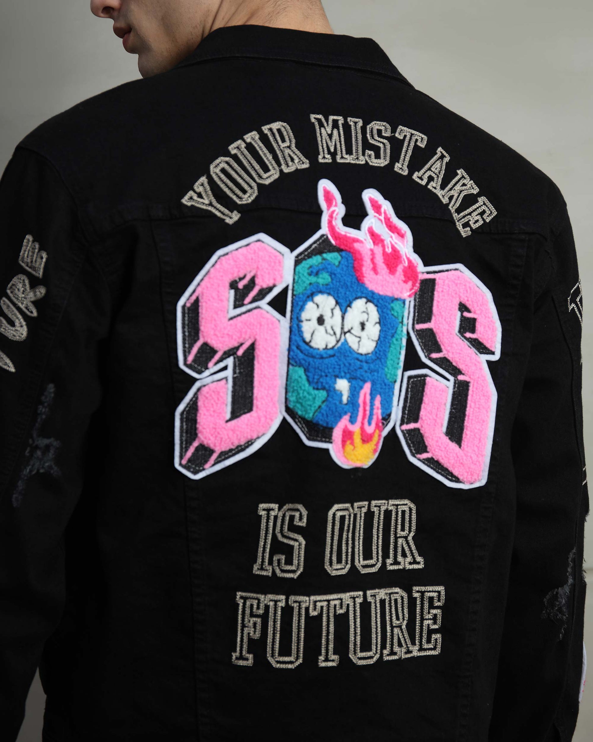 Logeqi ripped black denim jacket featuring a colorful graphic on the back with bold text design