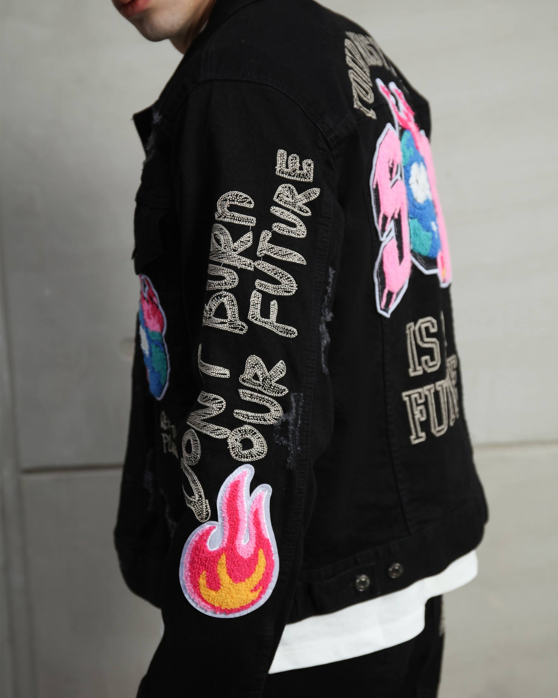 Logeqi ripped black denim jacket with colorful embroidered patches and graffiti-style text
