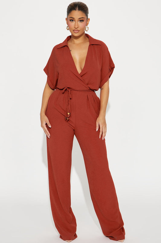Fashion Nova rust jumpsuit for women with a wrap style and wide-leg fit