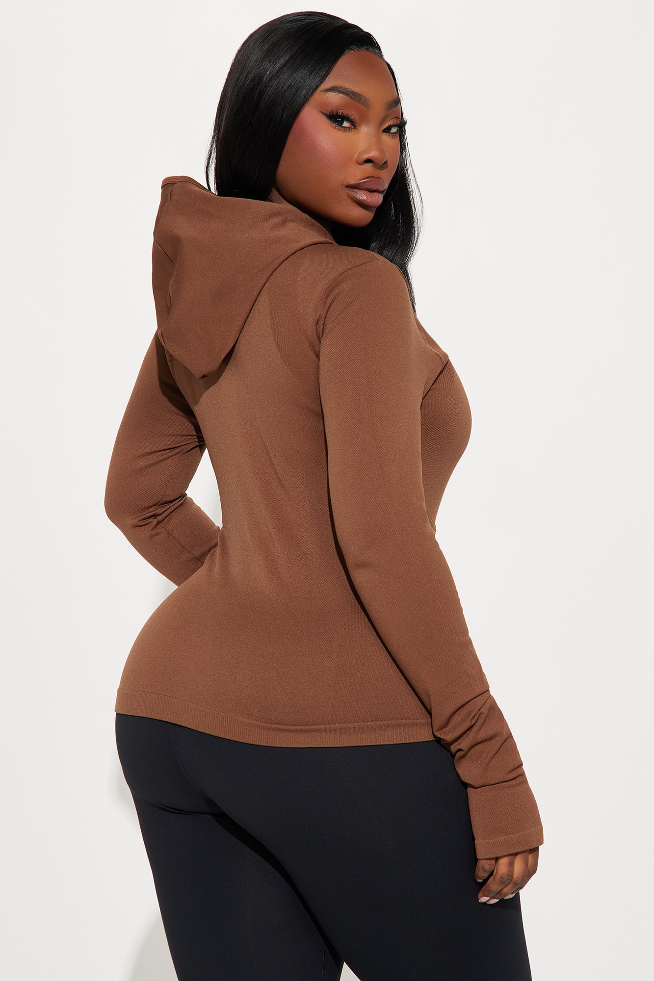 Brown seamless active jacket for women with a fitted design and hood, perfect for workouts