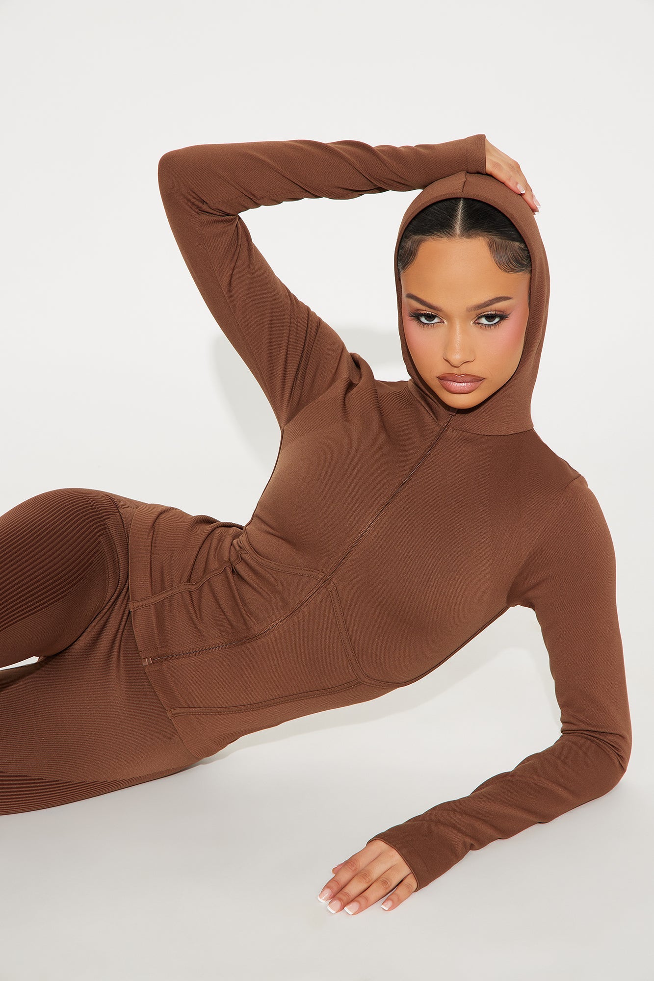 Brown seamless active jacket for women featuring a fitted design and hood for workout comfort