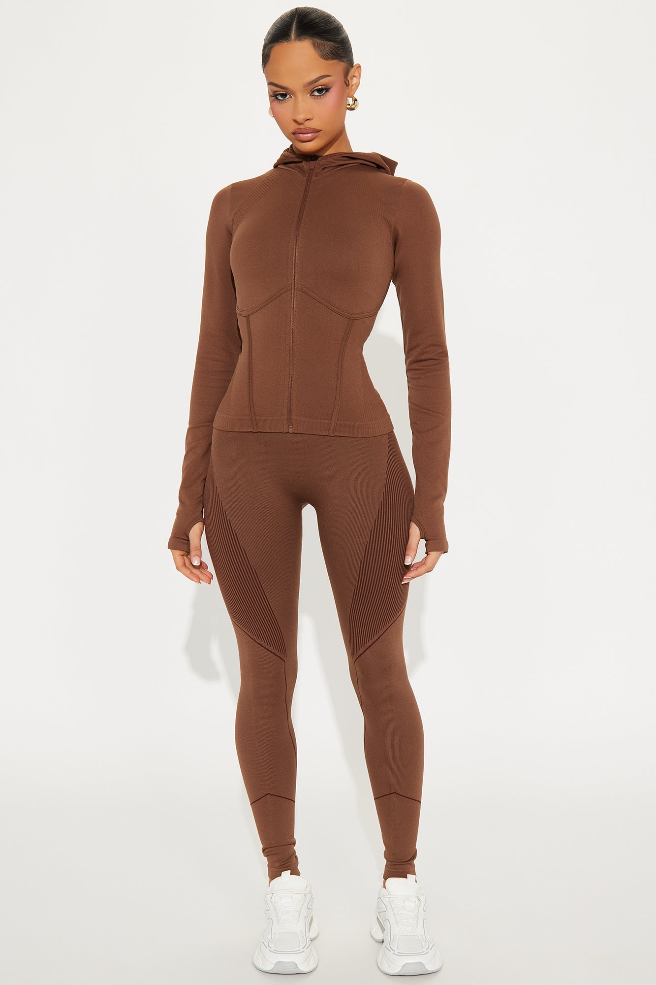 Stylish seamless active jacket for women in brown, featuring a fitted design and hood for workouts