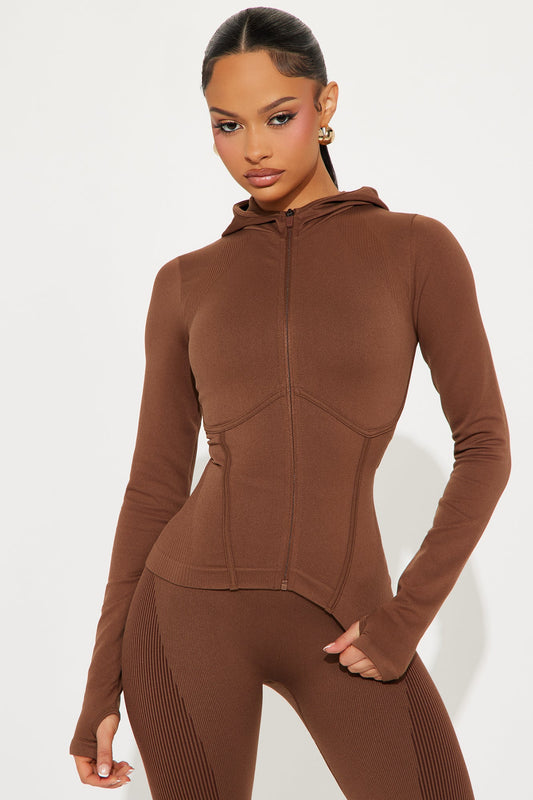 Brown seamless active jacket for women with a hood and form-fitting design from Fashion Nova