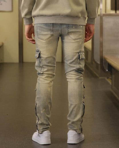 Logeqi spray painted blue cargo jeans with multiple pockets worn from the back