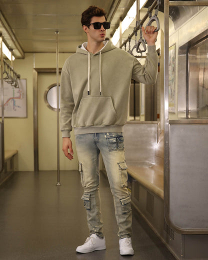 Logeqi spray painted blue cargo jeans worn by man in hoodie on subway train