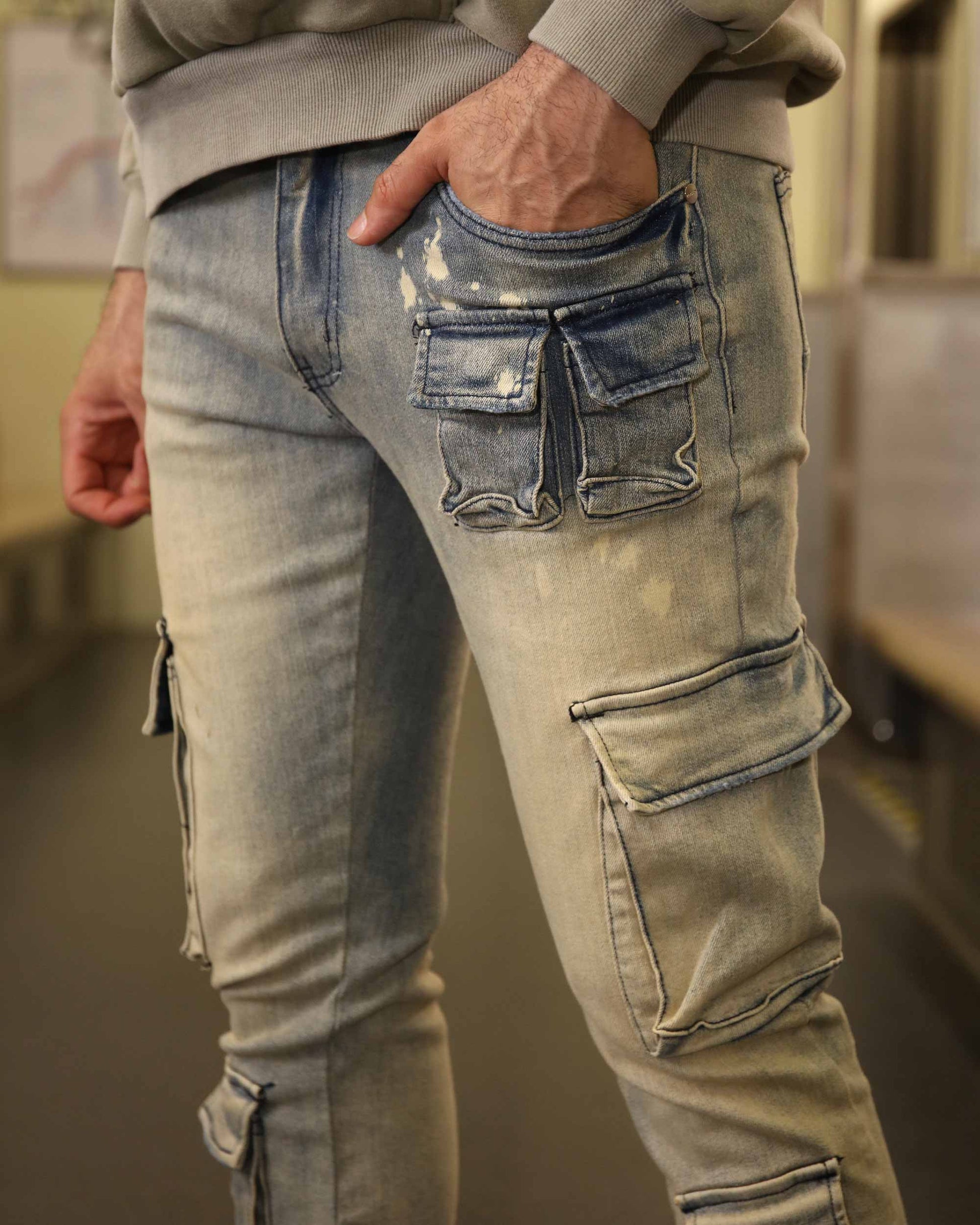 Logeqi spray painted blue cargo jeans with multiple pockets and distressed details