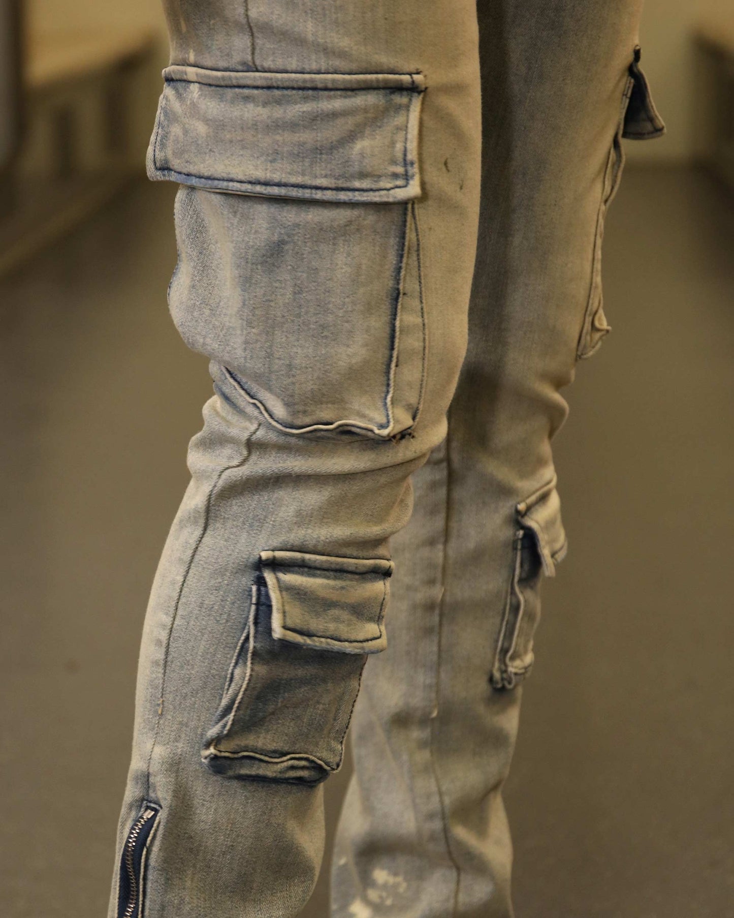 Logeqi spray painted blue cargo jeans featuring multiple pockets and distressed detailing