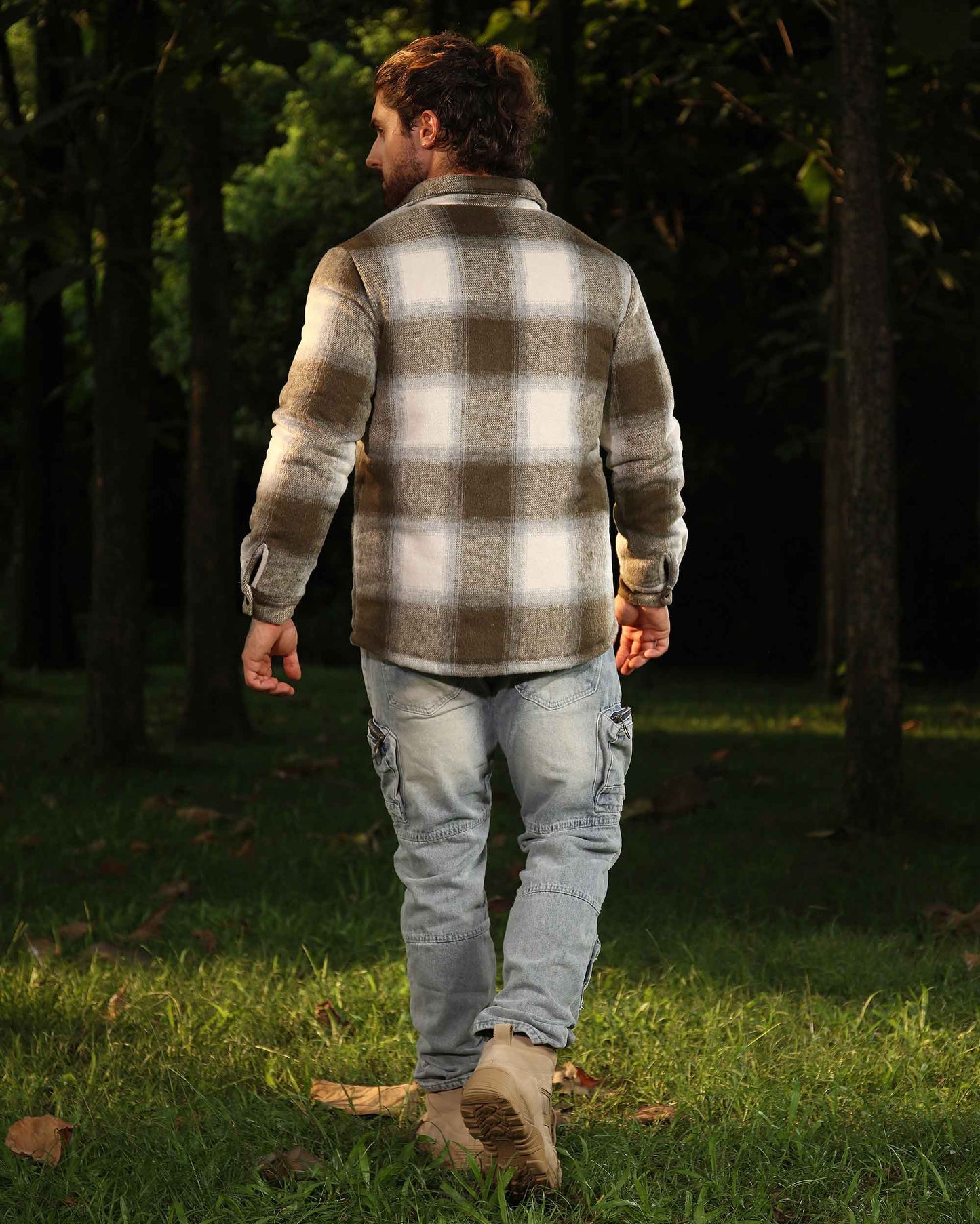 Man wearing Logeqi spring plaid jacket in beige and white walking outdoors in forest