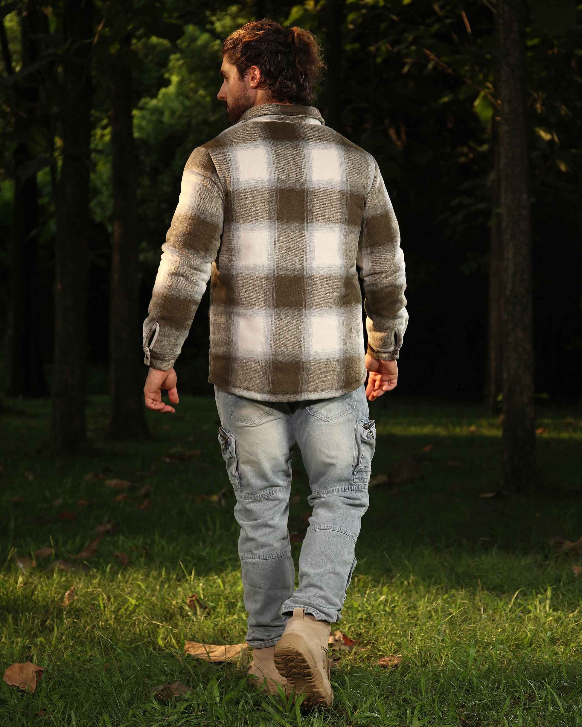 Man wearing Logeqi spring plaid jacket in beige and white walking outdoors in forest