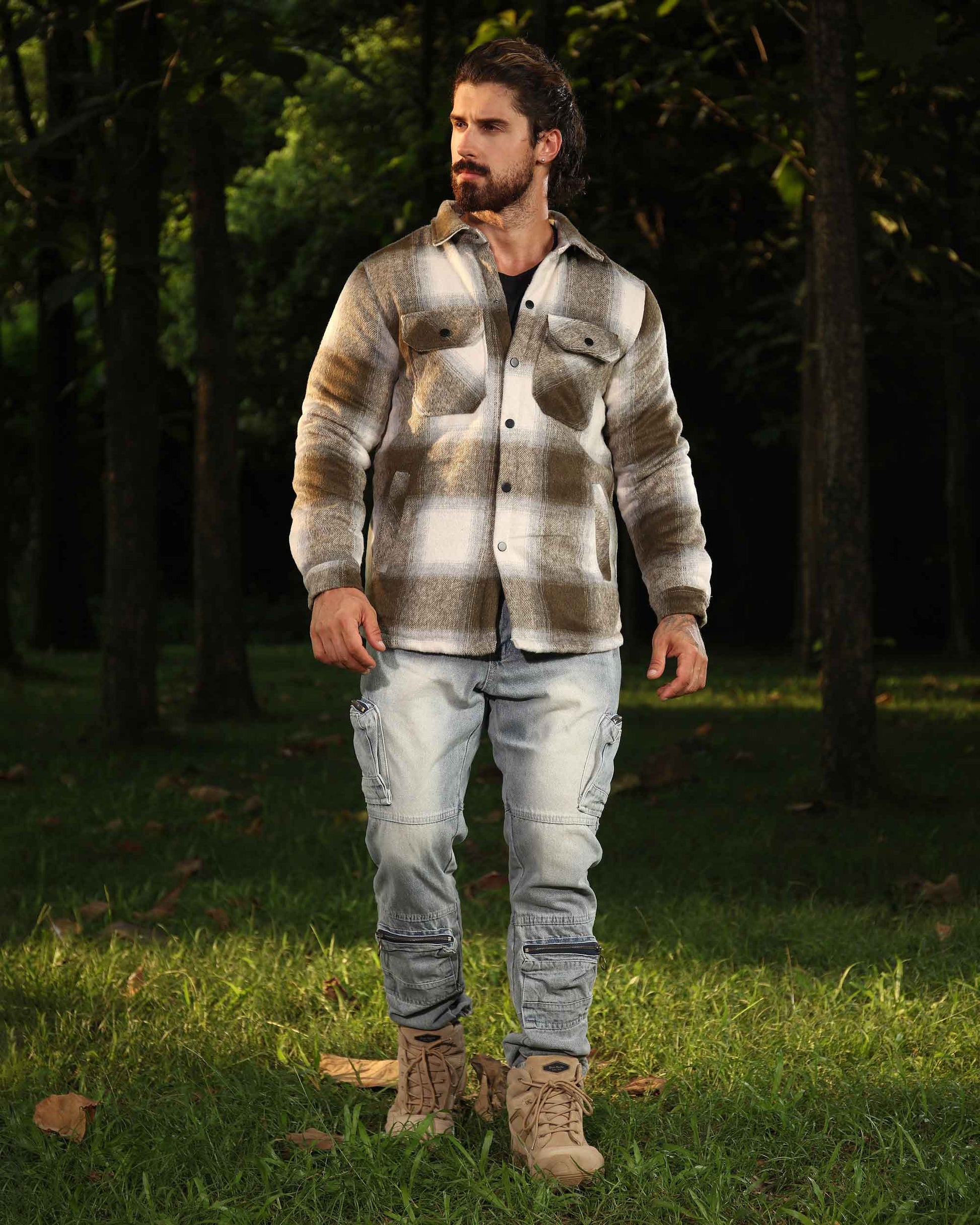 Man wearing Logeqi spring plaid jacket in neutral tones with light cargo pants outdoors