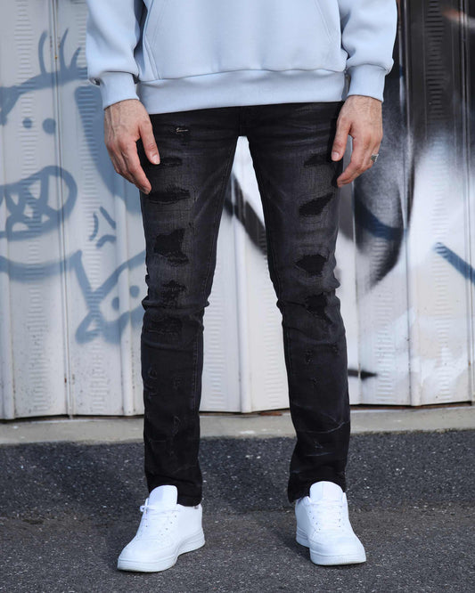 Logeqi street gothic ripped jeans in black worn with white sneakers and light sweatshirt