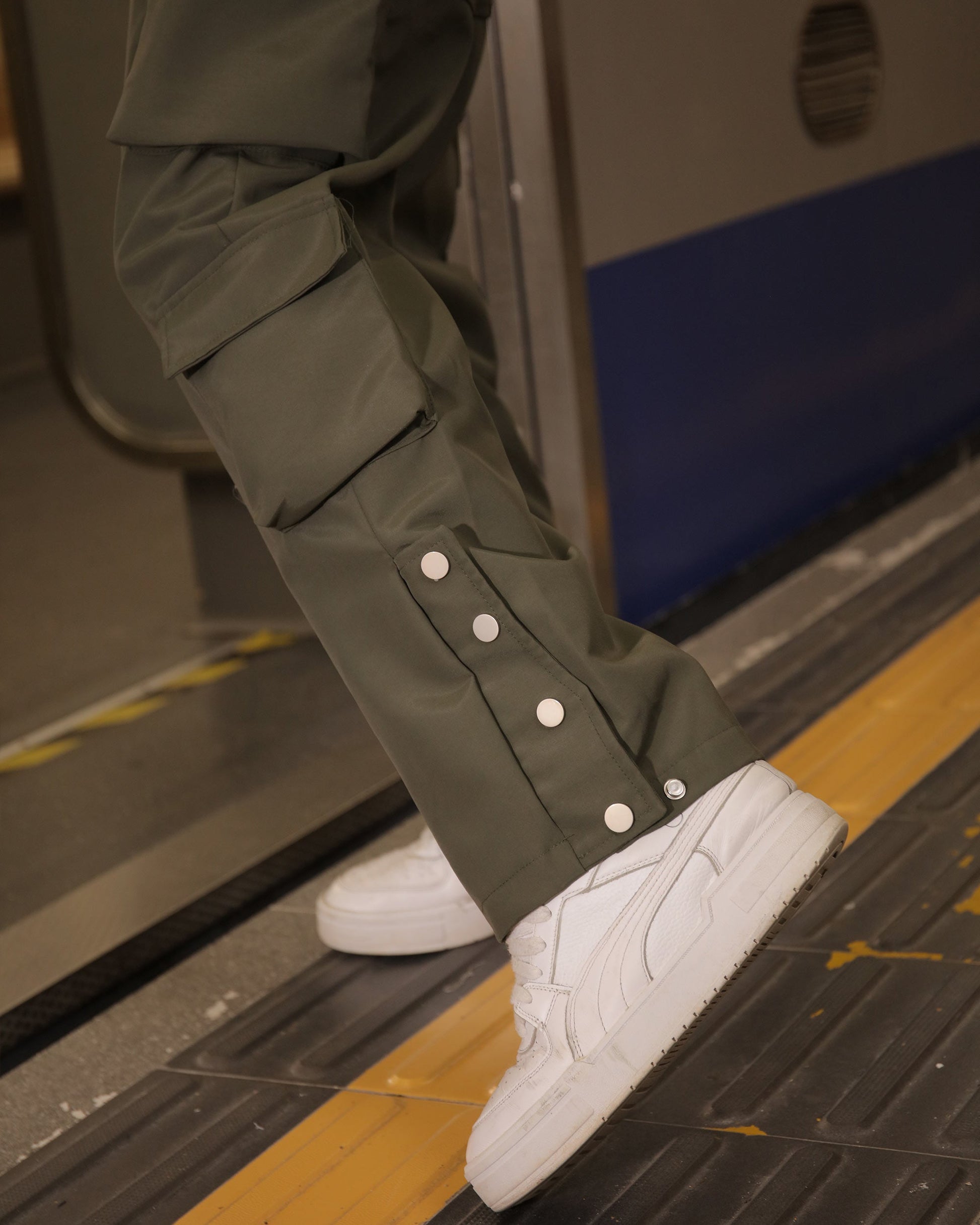 Logeqi stylish cargo pants for men in olive green with button details and white sneakers