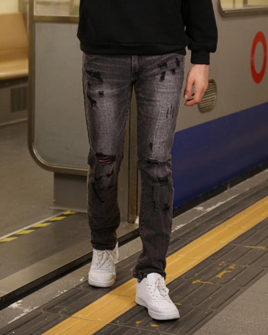 Logeqi stylish straight leg jeans in distressed black denim worn with white sneakers