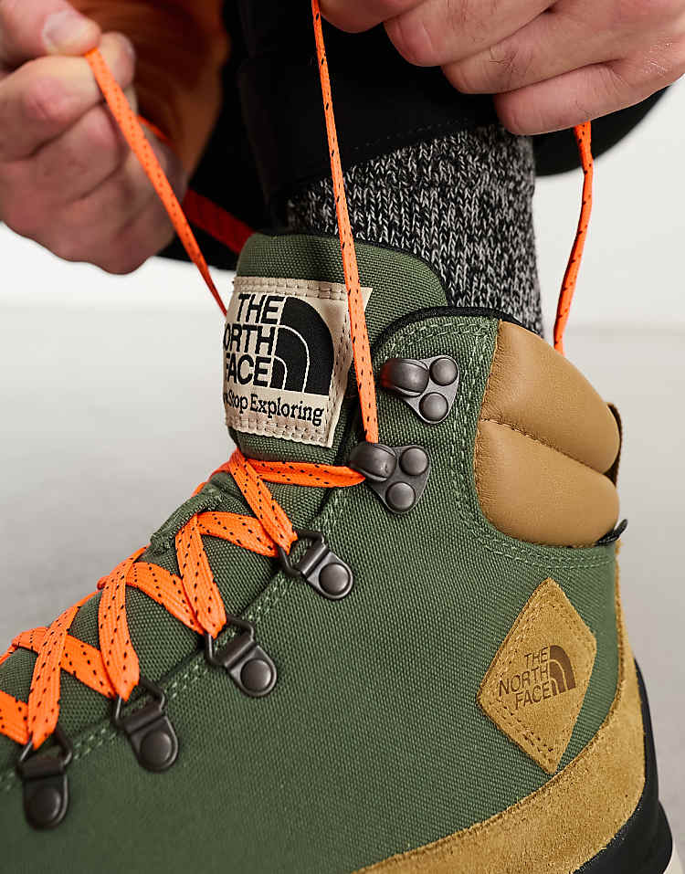 The North Face Back-To-Berkeley IV waterproof hiking boots with orange laces and green upper for outdoor adventures