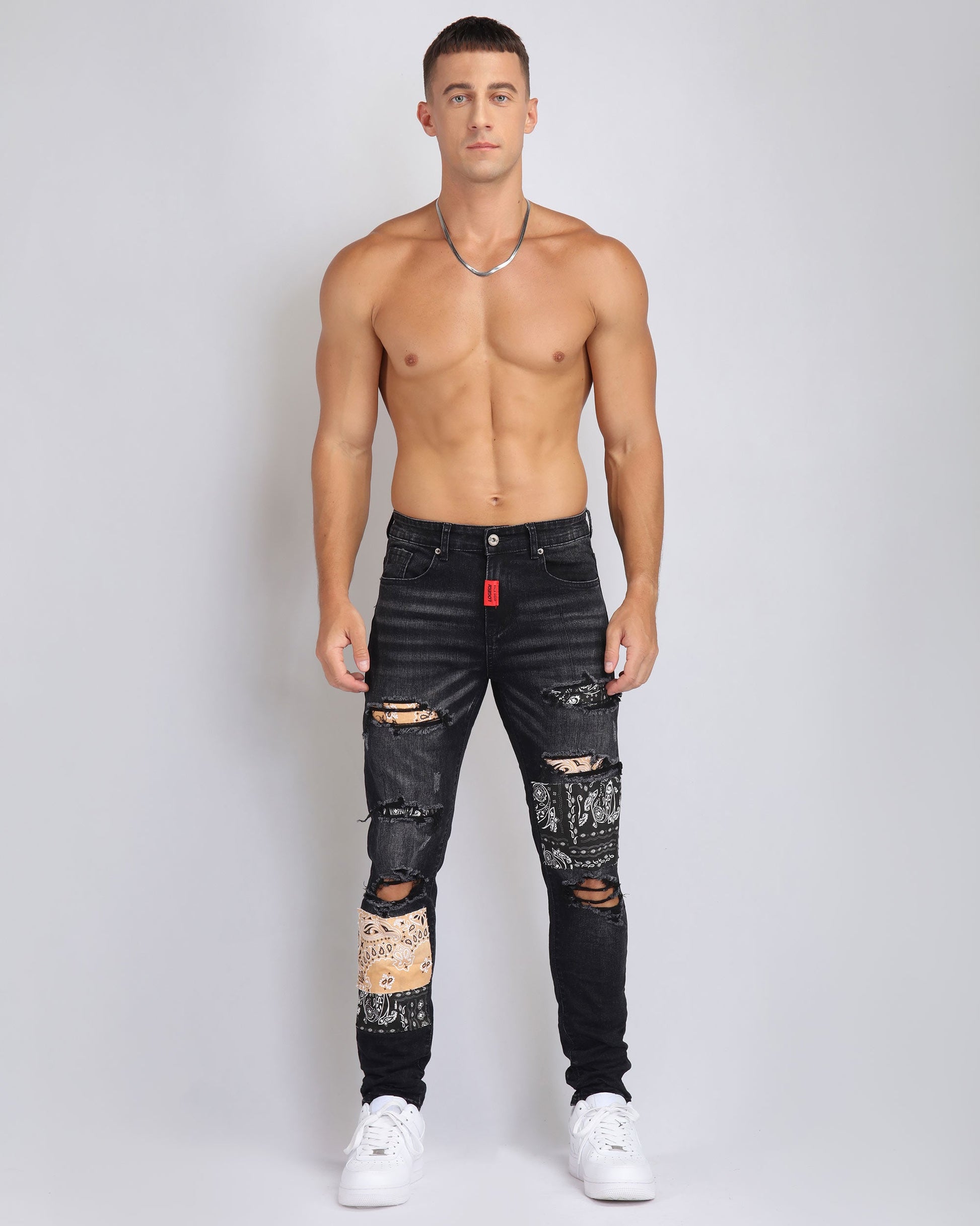 Trendy ripped black jeans for men featuring unique distressed details and a modern fit