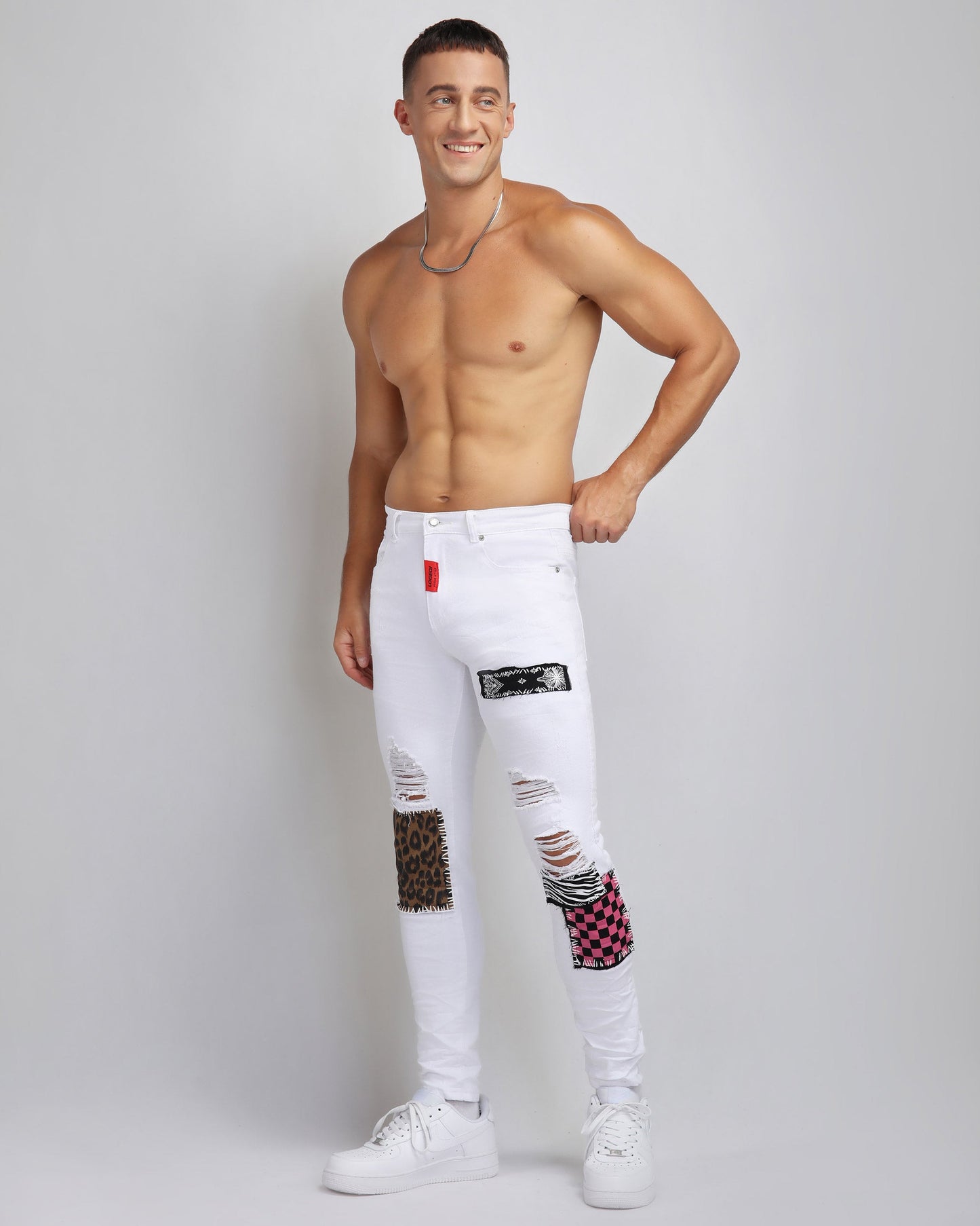 Trendy ripped white jeans by Logeqi featuring colorful patches and a stylish slim fit