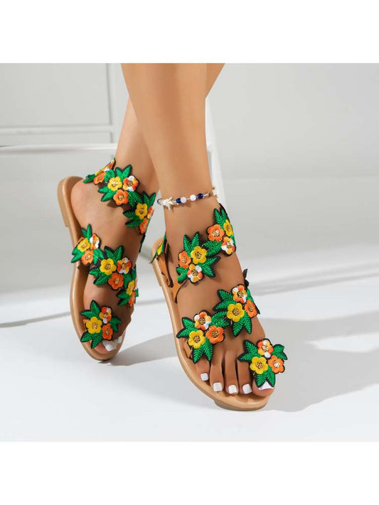 Wholesale7 tropical flower sandals with bright yellow and orange floral design on tan sole