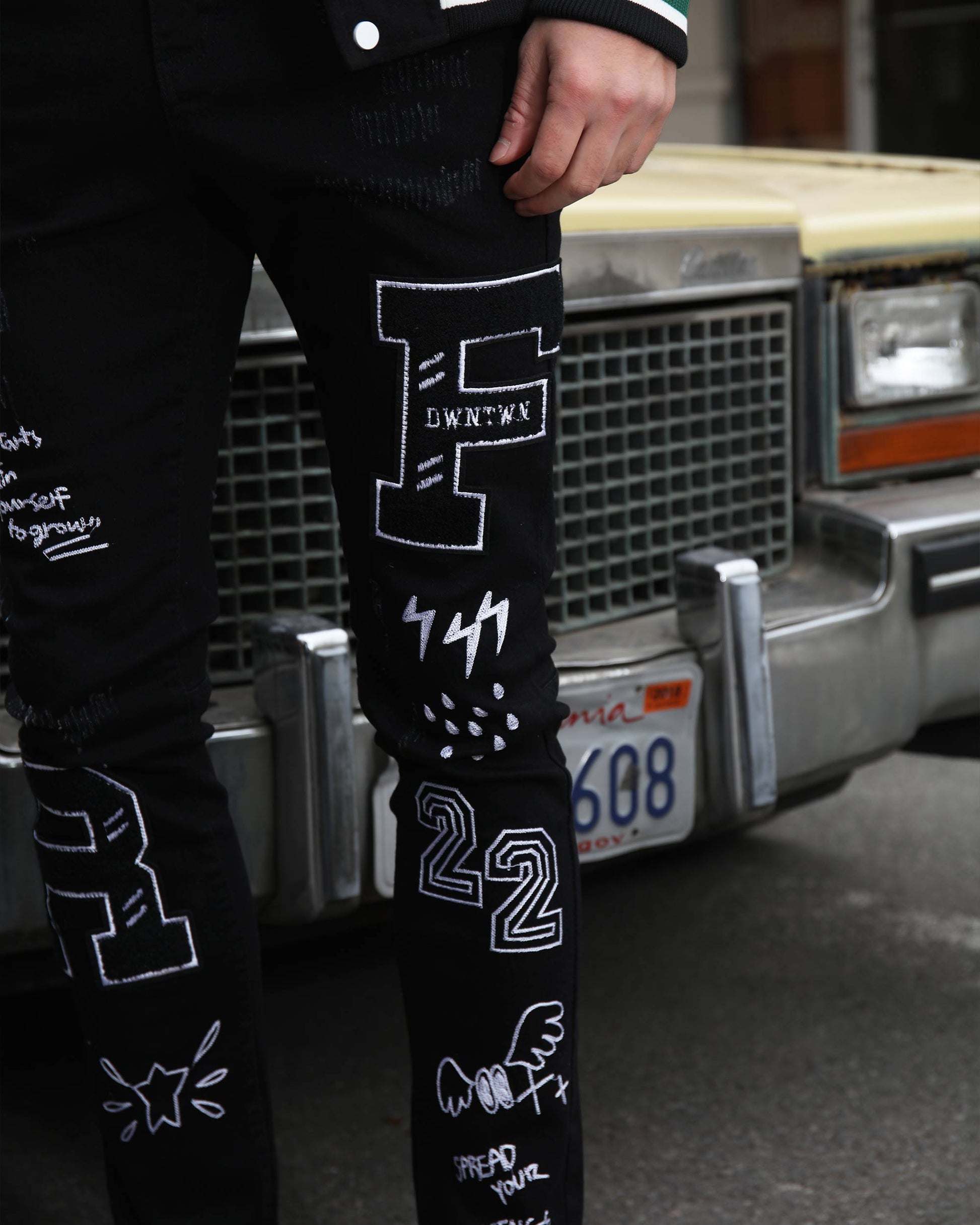 Logeqi urban graffiti jeans featuring unique white designs on black fabric for a trendy urban look