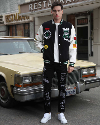 Model wearing urban graffiti jeans paired with a varsity jacket and sneakers in an urban setting