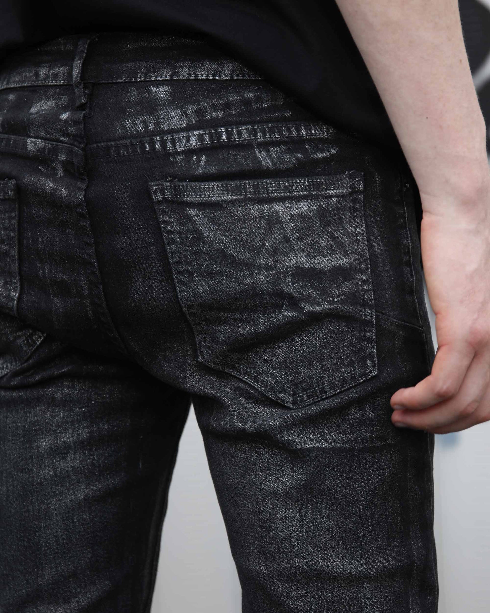 Logeqi gradient ripped black jeans close-up showing back pocket and distressed texture