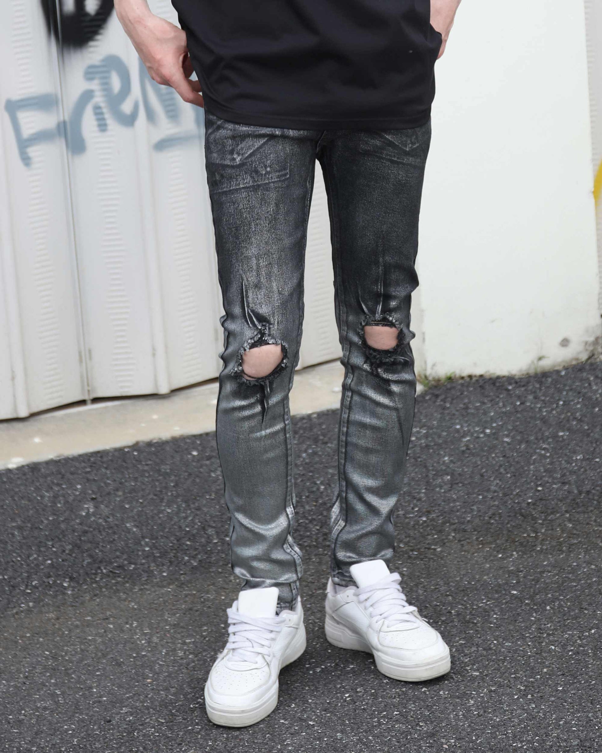 Logeqi gradient ripped black jeans with distressed knee holes worn with white sneakers