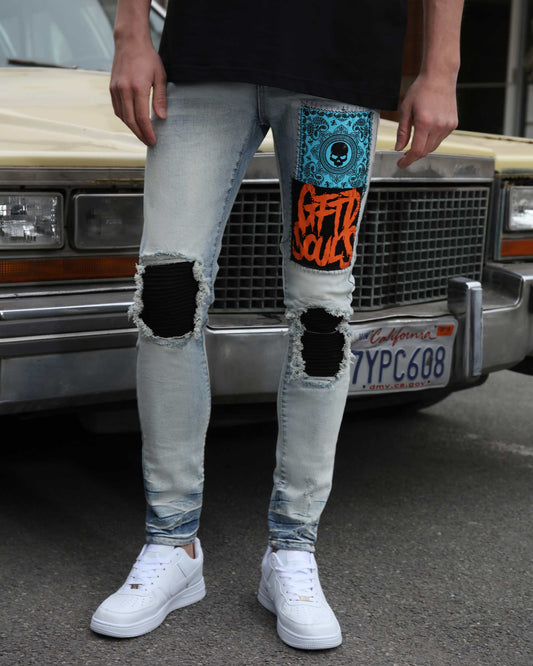 Logeqi light wash graffiti jeans with distressed knees and colorful patches worn with white sneakers