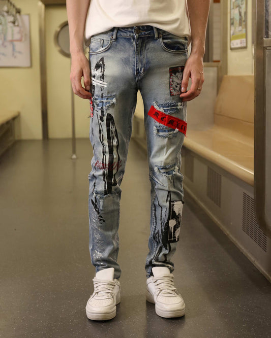 Logeqi medium wash ripped jeans with graphic patches worn by a person standing indoors