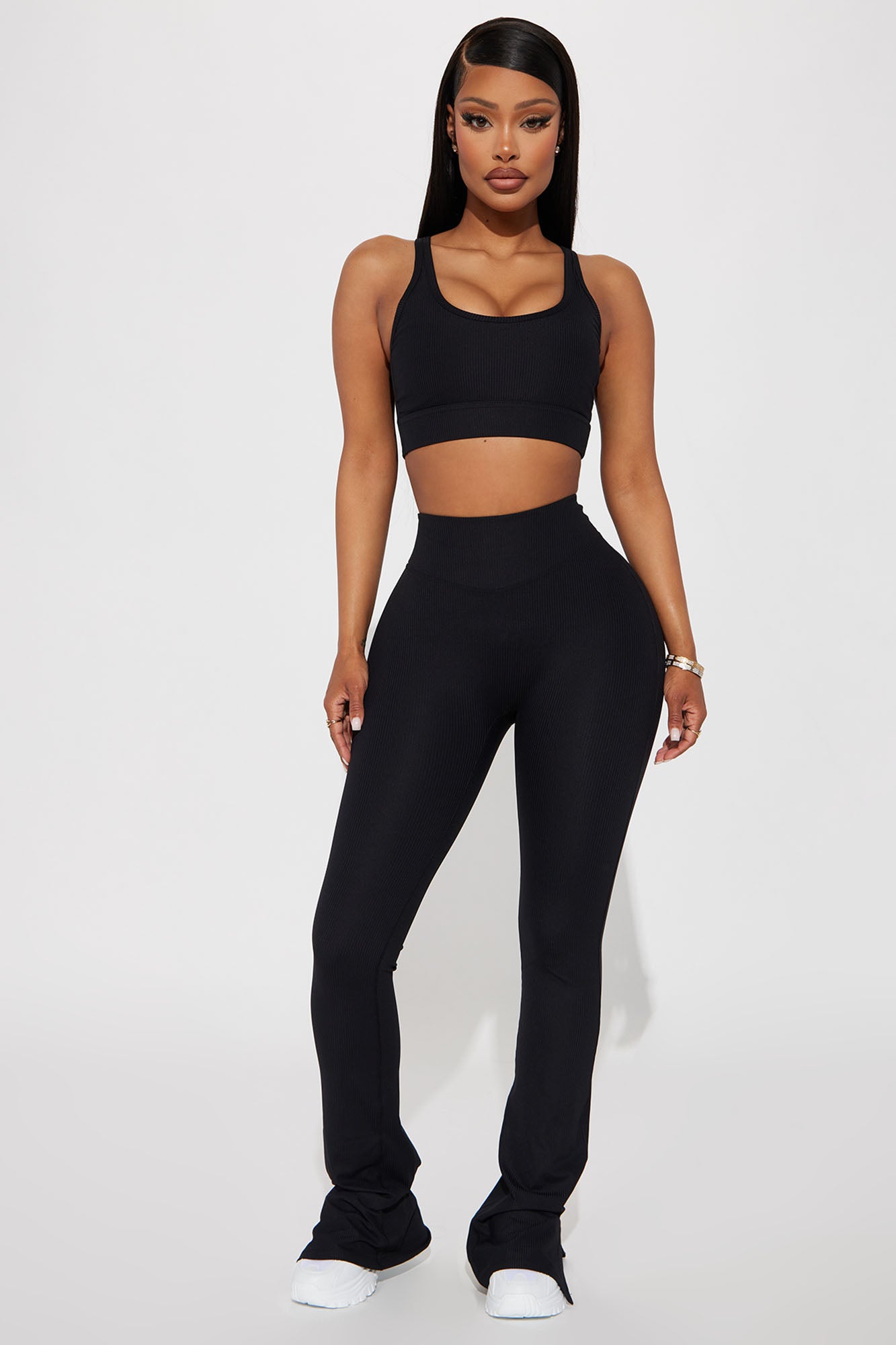 Model wearing seamless black yoga pants with matching crop top for a stylish workout look