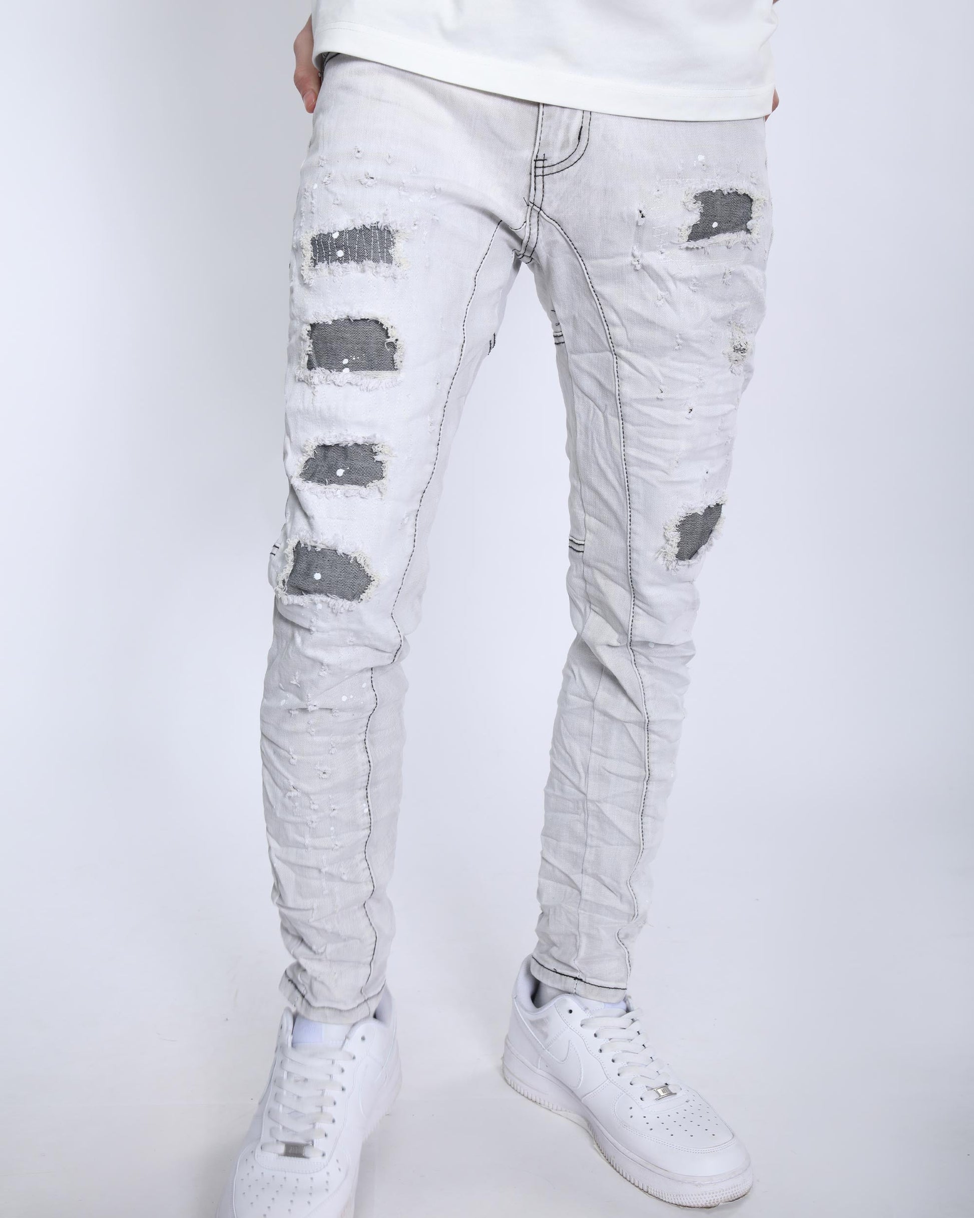 Logeqi slim fit gray distressed jeans with ripped details worn with white sneakers