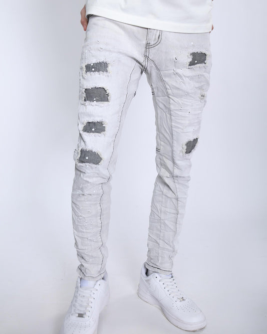 Logeqi slim fit gray distressed jeans with ripped details worn with white sneakers