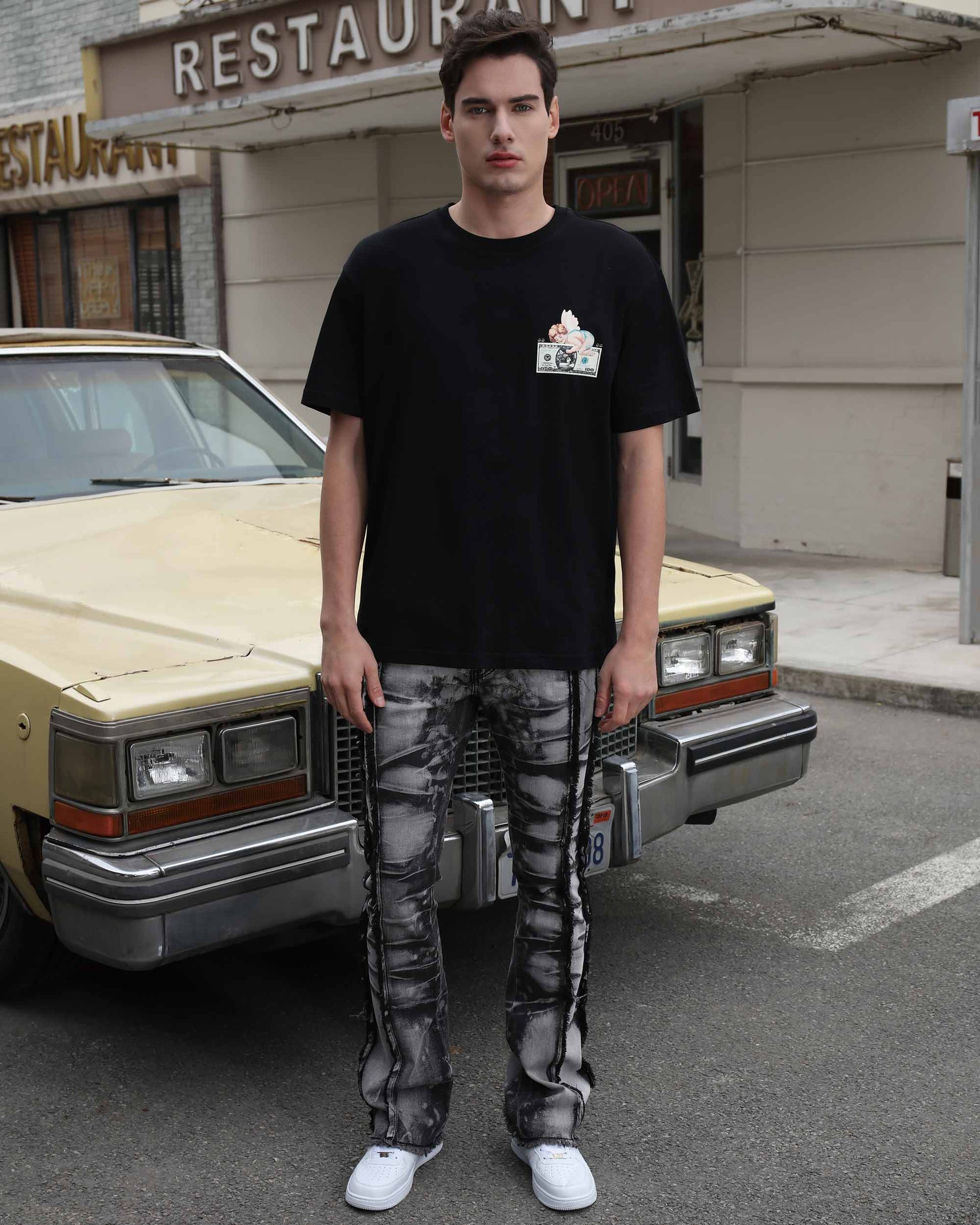 Logeqi vintage black jeans with a unique faded design, styled with a black graphic tee