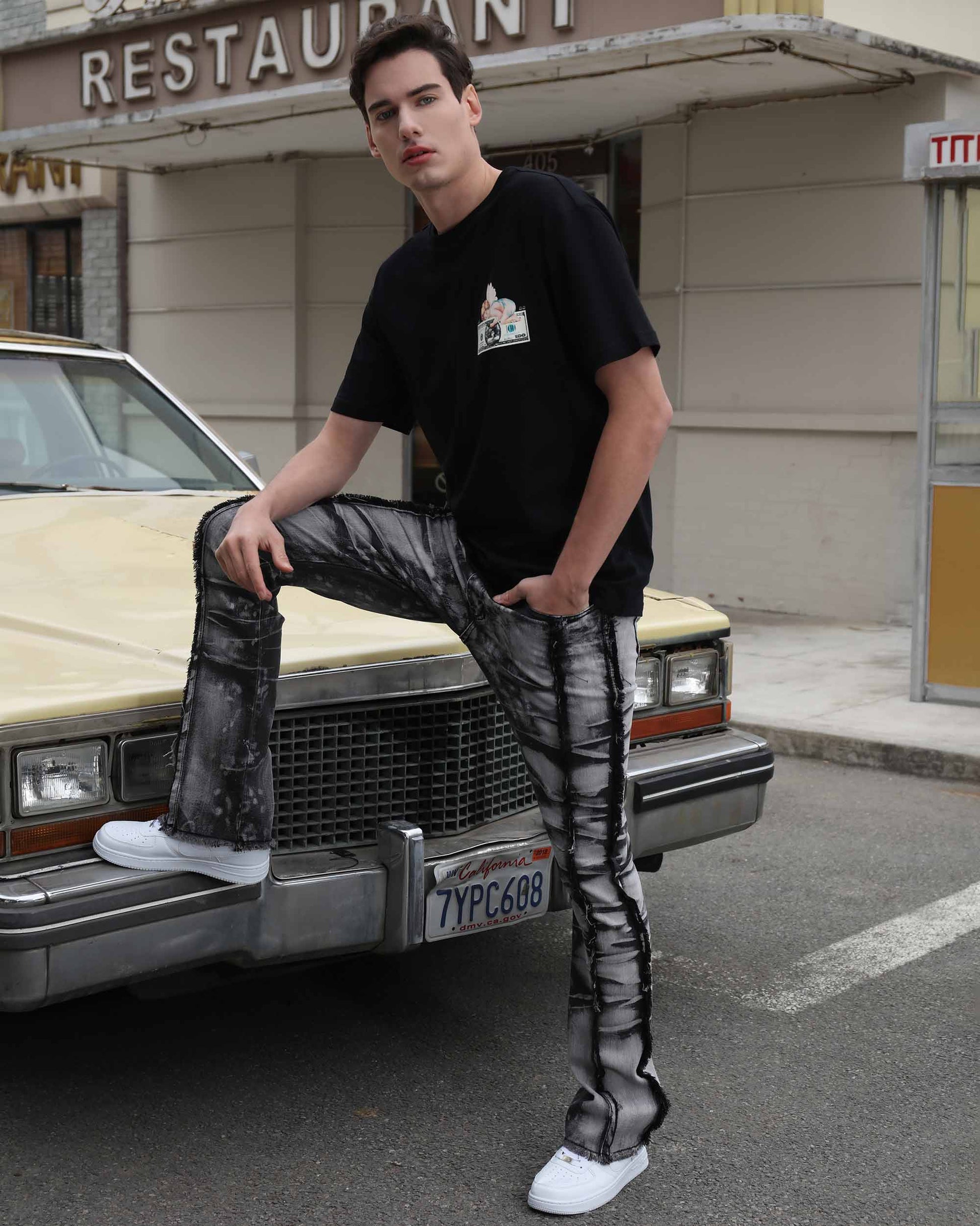 Logeqi vintage black jeans with a unique tie-dye pattern paired with a casual black t-shirt