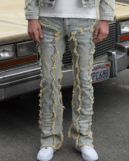 Logeqi vintage blue stacked jeans with distressed detailing and unique frayed seams