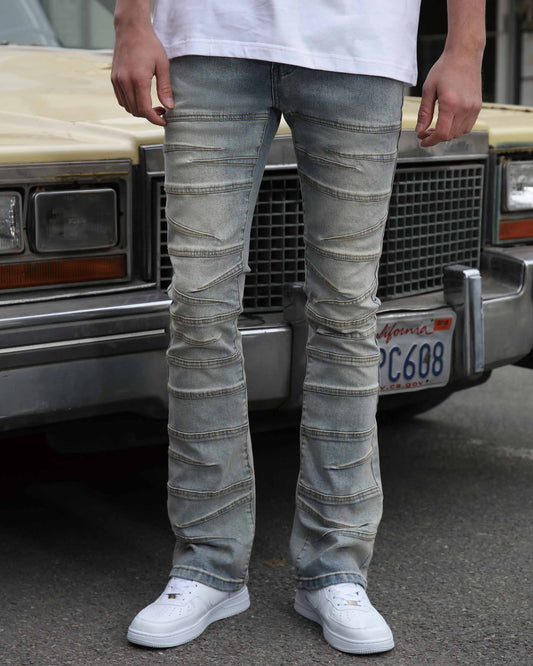 Logeqi vintage distressed blue jeans with detailed stitch patterns worn with white sneakers