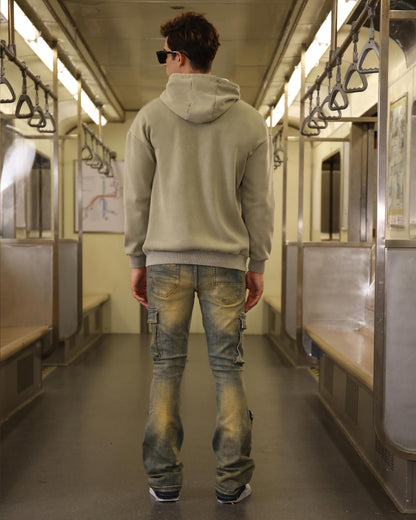 Logeqi vintage distressed cargo jeans on a model in a subway with a casual hoodie style