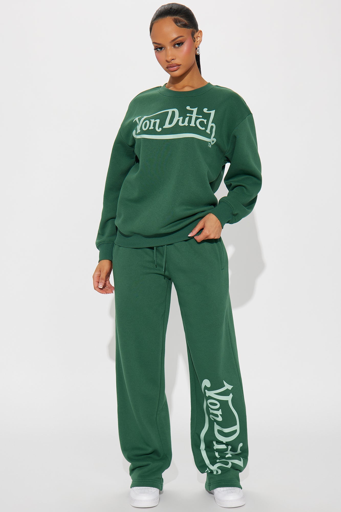 Von Dutch distressed crewneck sweatshirt paired with matching green jogger pants for a stylish casual look