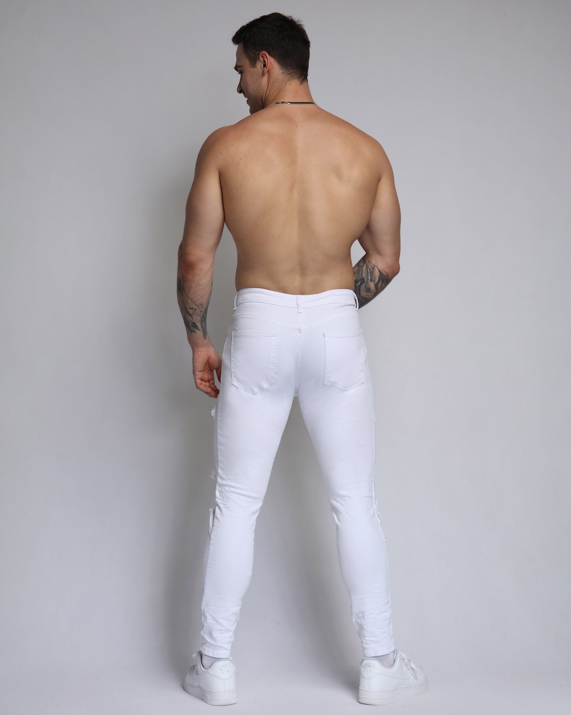 Men's Logeqi white ripped jeans with diamond patch, perfect for stylish and casual outfits
