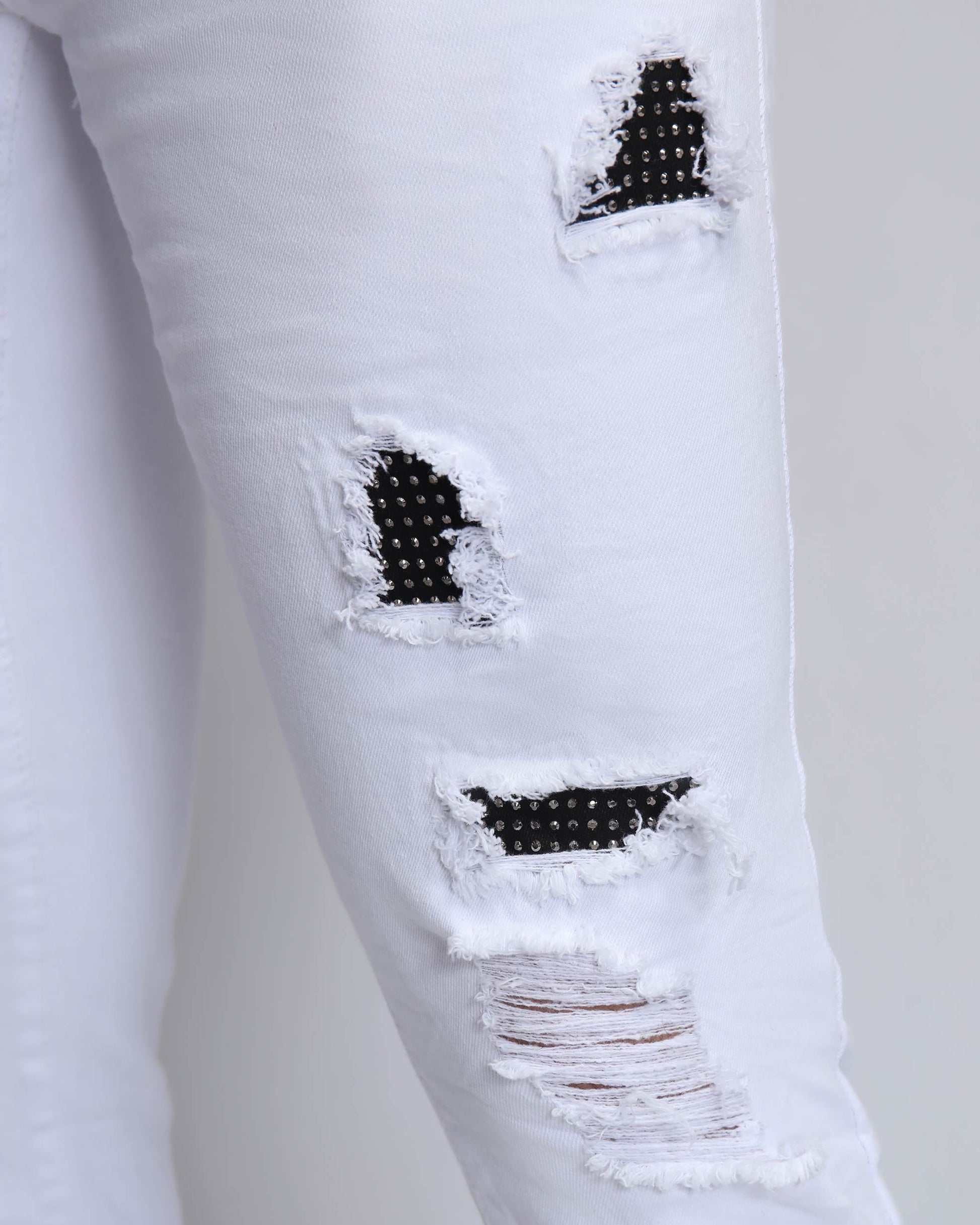 Logeqi white ripped jeans with diamond patch featuring unique distressed detailing