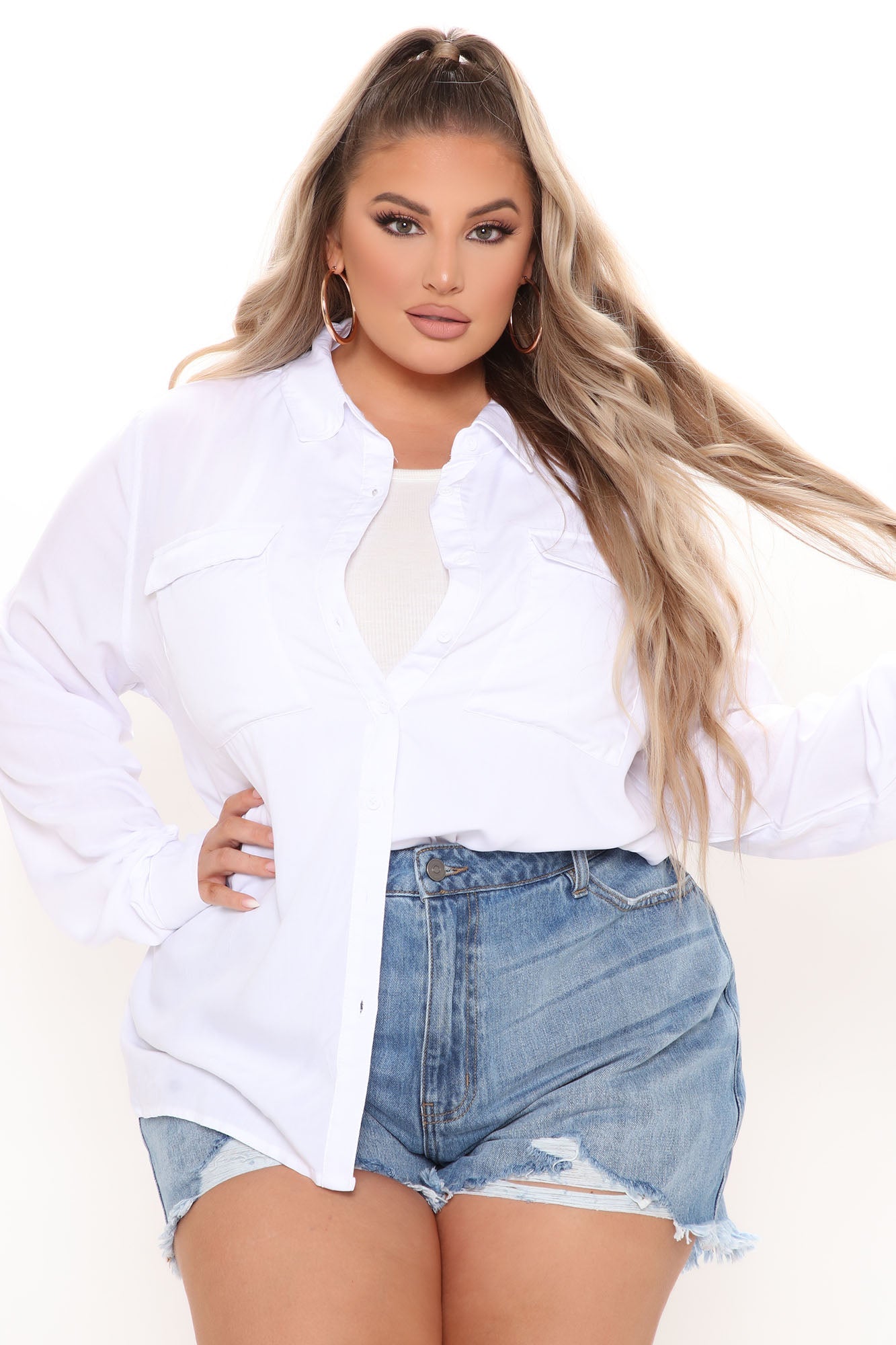 Fashion Nova white trendy button up shirt for women styled with denim shorts for a casual look
