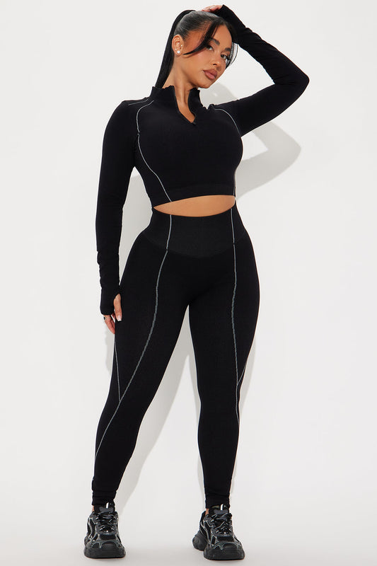 Fashion Nova women's black activewear set featuring a cropped top and high-waisted leggings